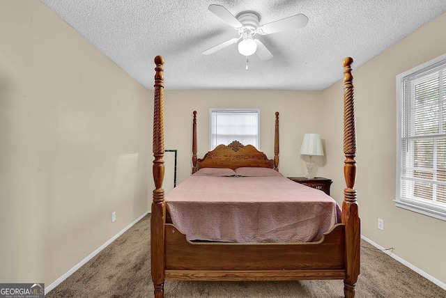 carpeted bedroom with ceiling fan and a textured ceiling