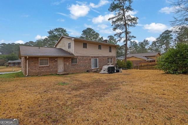 back of house with a lawn