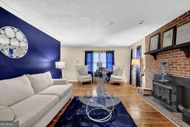 living room featuring hardwood / wood-style flooring, a wood stove, and a textured ceiling