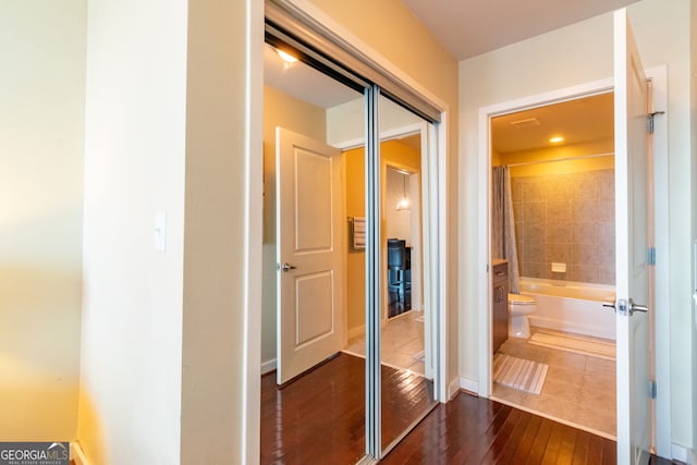 corridor with dark hardwood / wood-style floors