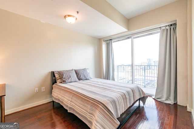 bedroom featuring dark hardwood / wood-style floors and access to outside