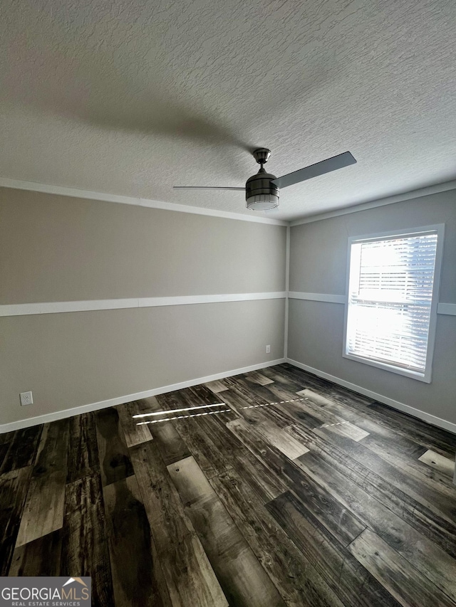 empty room featuring dark hardwood / wood-style flooring, ceiling fan, and a textured ceiling