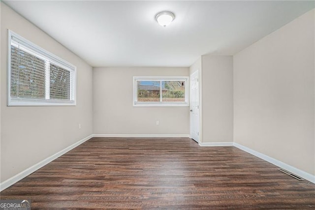 unfurnished room featuring dark hardwood / wood-style flooring