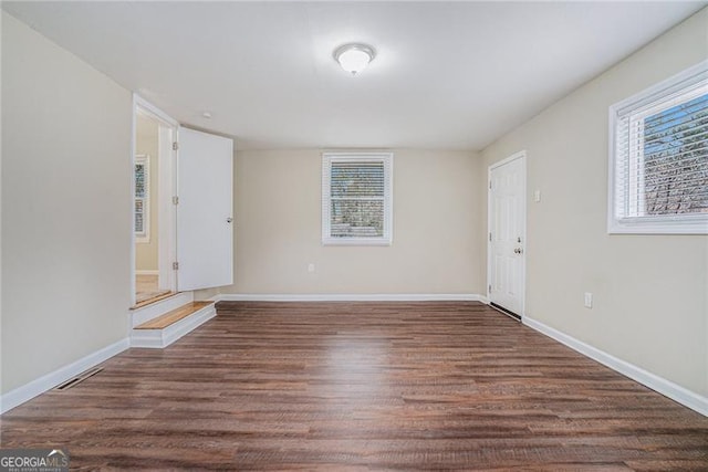 spare room with dark hardwood / wood-style floors