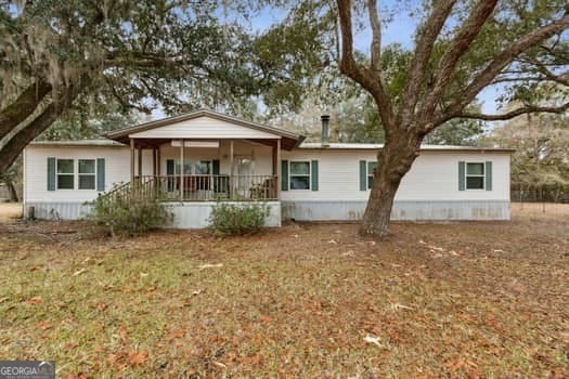 view of front of home with a porch and a front yard