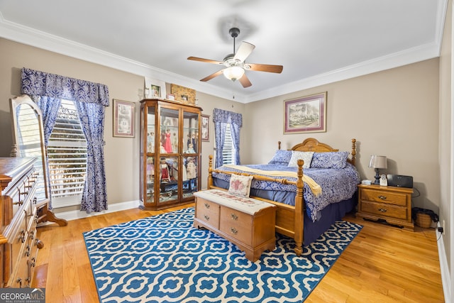 bedroom featuring crown molding, light hardwood / wood-style flooring, and ceiling fan