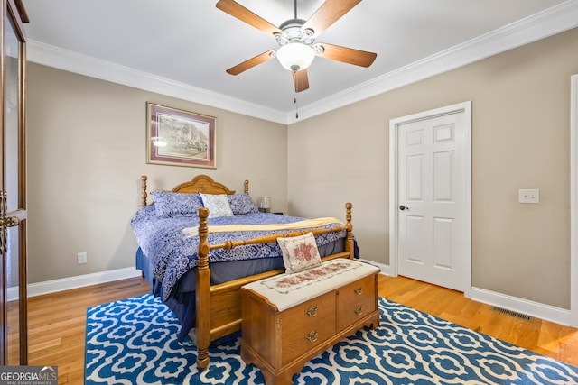 bedroom with ornamental molding, light hardwood / wood-style floors, and ceiling fan