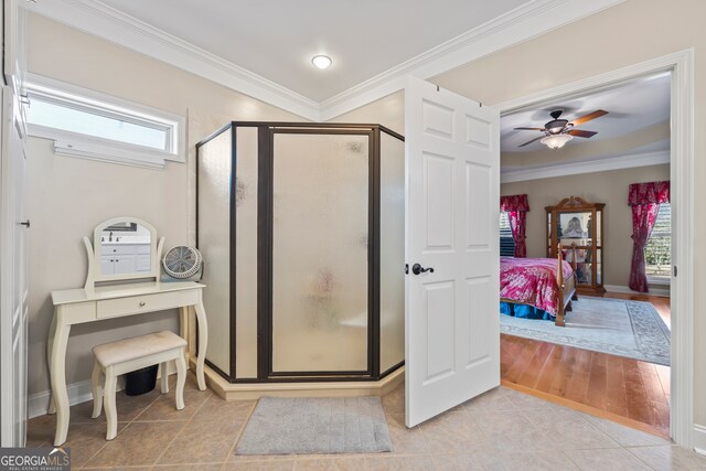 bathroom featuring walk in shower, ceiling fan, ornamental molding, and tile patterned flooring