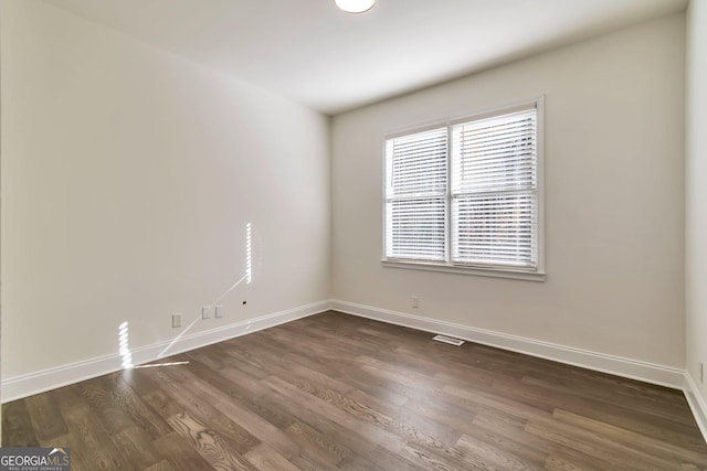 empty room with dark hardwood / wood-style floors