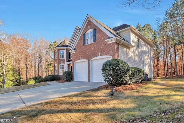 view of side of property with a garage and a yard