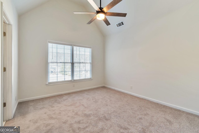 spare room with ceiling fan, light colored carpet, and high vaulted ceiling