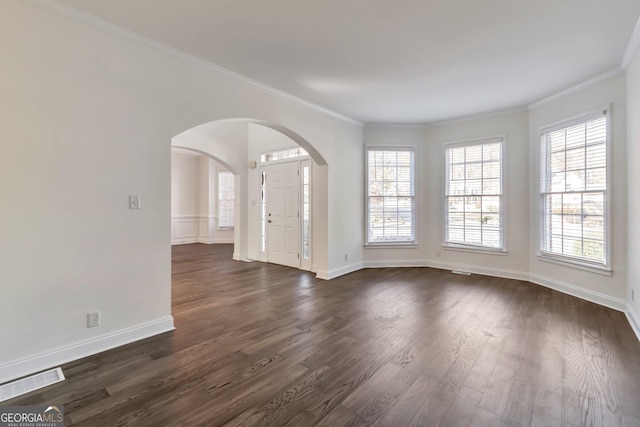 unfurnished room featuring crown molding and dark wood-type flooring