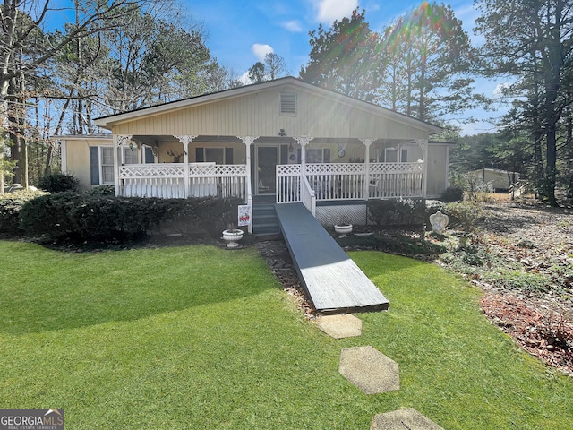 view of front of home with a porch and a front lawn