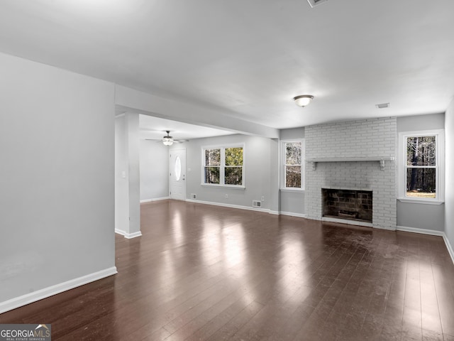 unfurnished living room with ceiling fan, dark hardwood / wood-style floors, and a fireplace