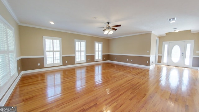 unfurnished living room featuring light hardwood / wood-style flooring, ornamental molding, and ceiling fan