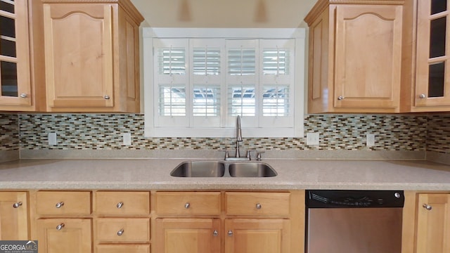 kitchen featuring tasteful backsplash, light brown cabinetry, dishwasher, and sink