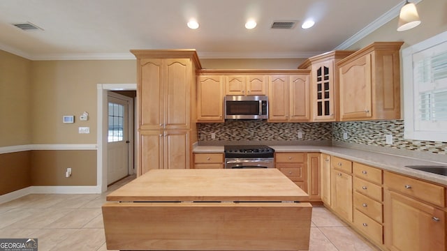 101 Willow Ridge Cir, Thomasville, GA 31757 - kitchen with appliances with stainless steel finishes, light brown cabinetry, light tile patterned floors, decorative backsplash, and ornamental molding