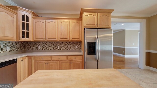 101 Willow Ridge Cir, Thomasville, GA 31757 - kitchen with stainless steel appliances, light brown cabinets, light countertops, glass insert cabinets, and crown molding