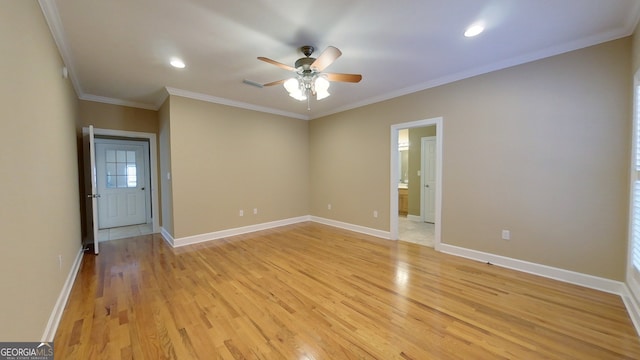 empty room featuring ornamental molding, light hardwood / wood-style floors, and ceiling fan