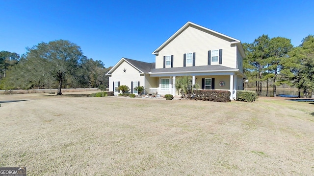 view of front of house featuring a front lawn and covered porch