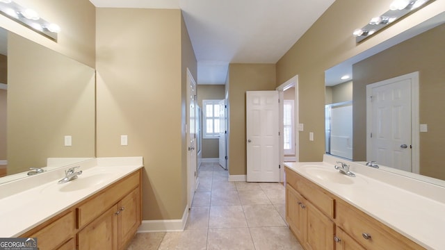 bathroom featuring a shower with door, vanity, and tile patterned flooring