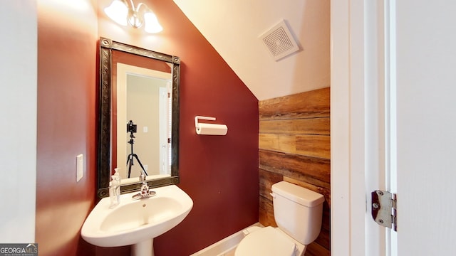 101 Willow Ridge Cir, Thomasville, GA 31757 - half bath with a sink, toilet, vaulted ceiling, and wood walls