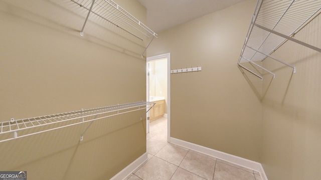 spacious closet featuring light tile patterned flooring