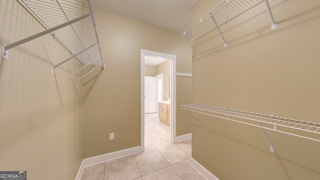 walk in closet featuring light tile patterned flooring