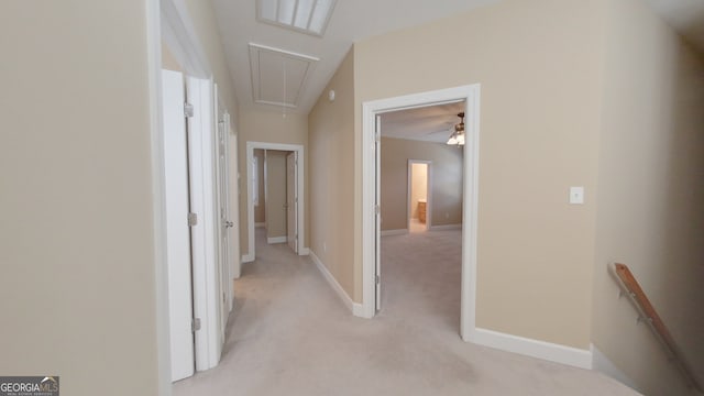 corridor featuring light colored carpet