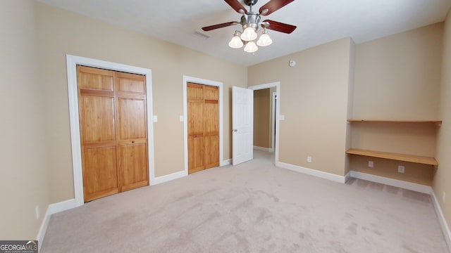 unfurnished bedroom with ceiling fan and light colored carpet