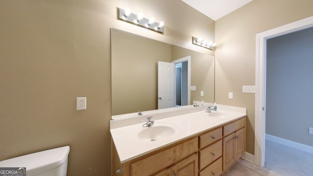 bathroom featuring tile patterned floors, vanity, and toilet