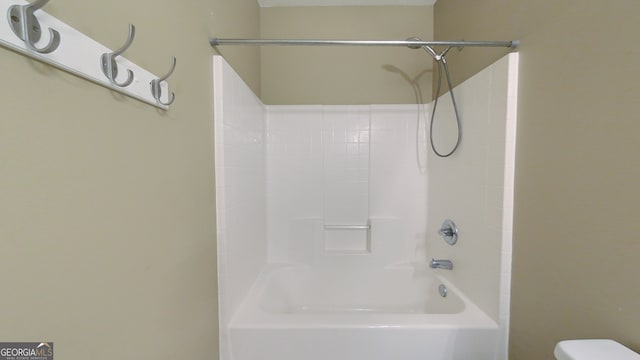 bathroom featuring  shower combination and toilet