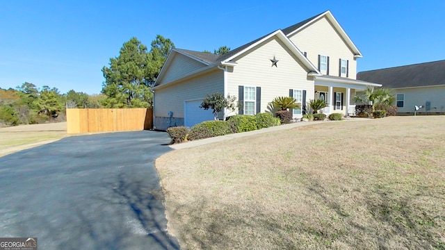 front facade featuring a garage and a front yard