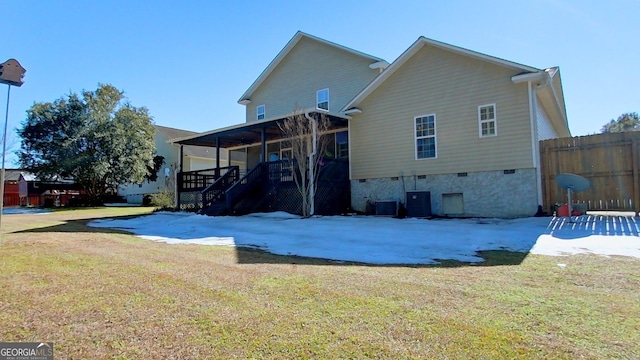 rear view of house with a patio, central AC, and a lawn