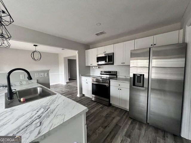 305 Clairemore Cir, Hinesville, GA 31313 - kitchen featuring a sink, stainless steel appliances, white cabinetry, dark wood-type flooring, and visible vents