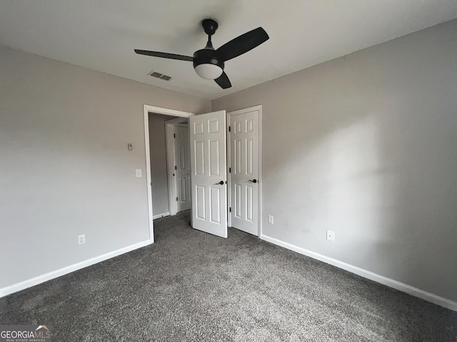 305 Clairemore Cir, Hinesville, GA 31313 - unfurnished bedroom featuring baseboards, visible vents, and dark colored carpet