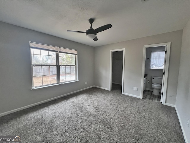 305 Clairemore Cir, Hinesville, GA 31313 - unfurnished bedroom featuring a closet, baseboards, a walk in closet, carpet flooring, and ensuite bath