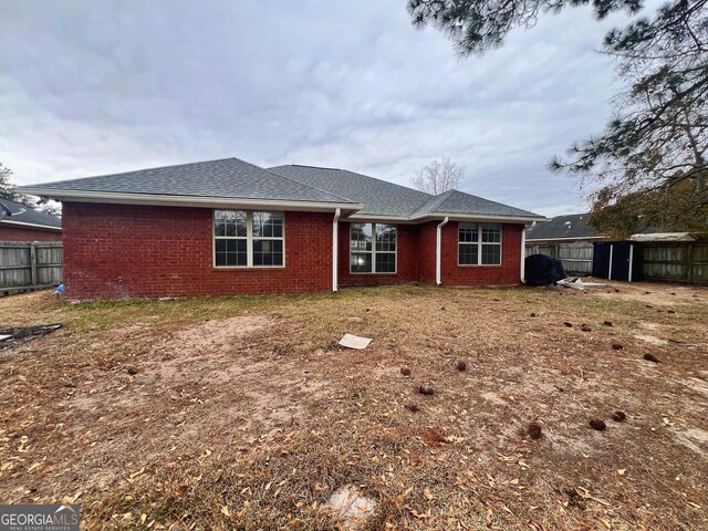 305 Clairemore Cir, Hinesville, GA 31313 - back of property with brick siding, fence, and roof with shingles