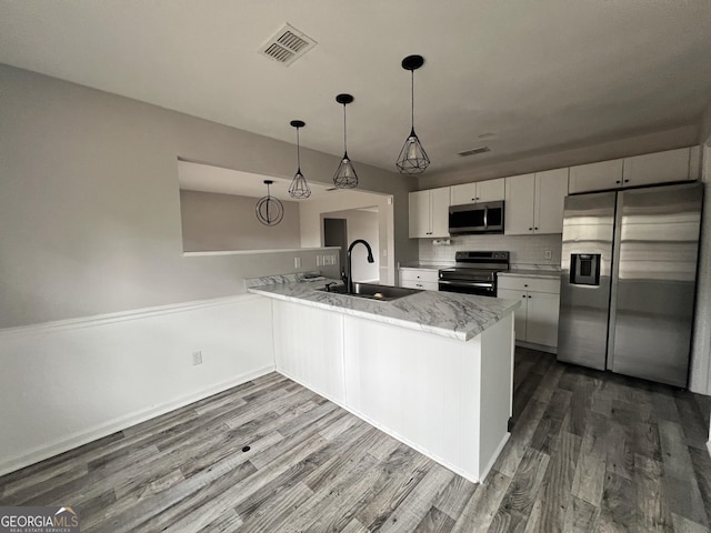 kitchen featuring sink, white cabinetry, decorative light fixtures, kitchen peninsula, and stainless steel appliances