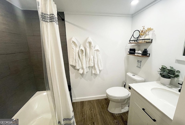 full bathroom with vanity, toilet, hardwood / wood-style floors, and shower / bath combo with shower curtain