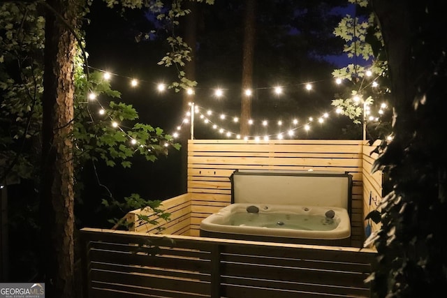 patio at twilight with a hot tub