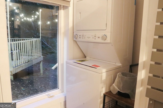 laundry area featuring stacked washer / drying machine