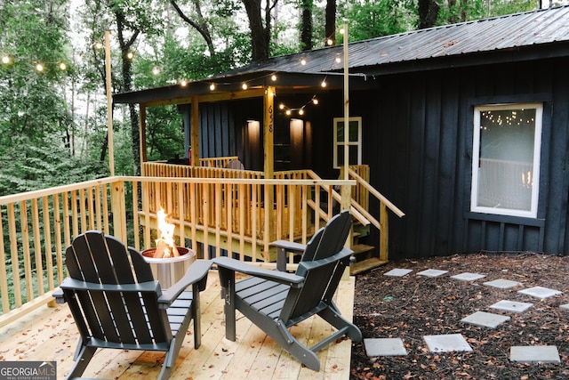 wooden terrace featuring a fire pit