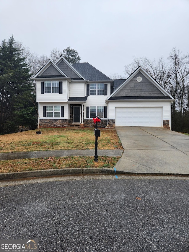 view of front of home with a garage and a front lawn