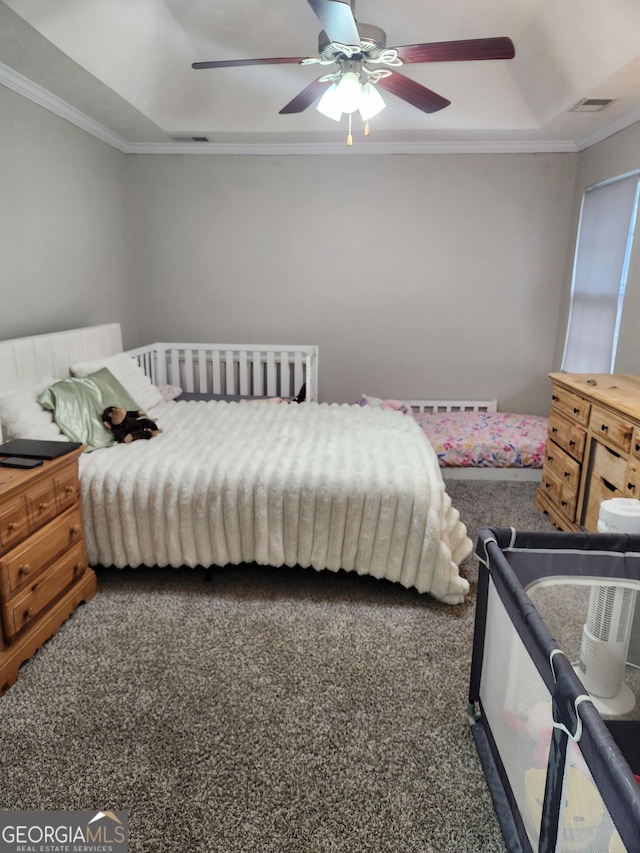 carpeted bedroom with crown molding, a raised ceiling, and ceiling fan