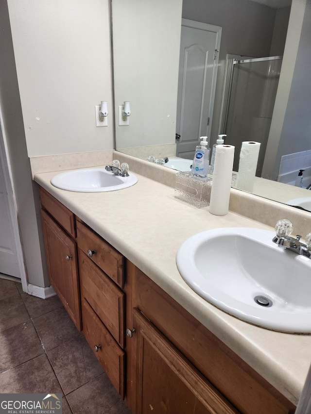 bathroom with vanity, an enclosed shower, and tile patterned flooring