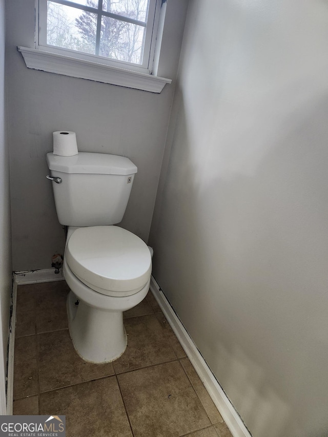 bathroom with tile patterned flooring and toilet