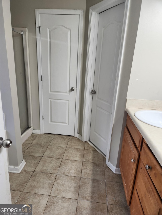 bathroom with vanity, tile patterned flooring, and a shower with shower door