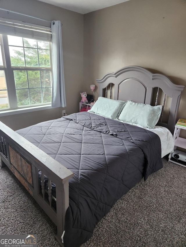 bedroom with dark colored carpet