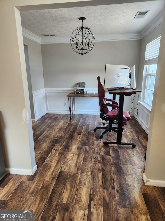 office space with an inviting chandelier, dark hardwood / wood-style flooring, ornamental molding, and a textured ceiling